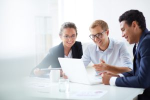 Portrait,Of,Smart,Business,Partners,Using,Laptop,At,Meeting