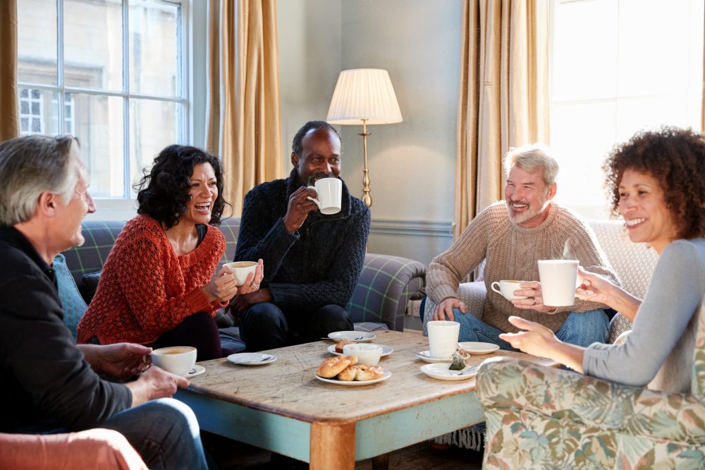 Group,Of,Middle,Aged,Friends,Meeting,Around,Table,In,Coffee