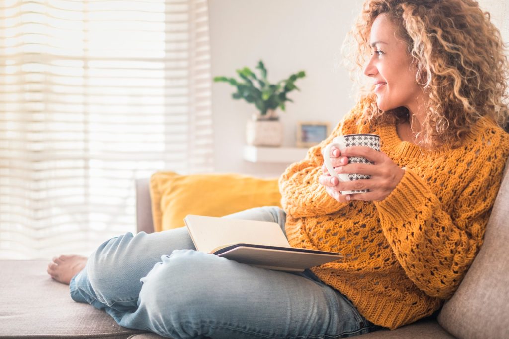 Woman drinking tea with a notebook